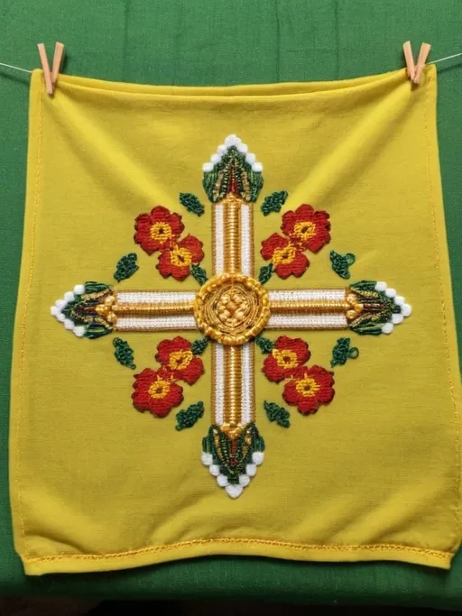 Prompt: a yellow top with a gold beaded design on it sitting on a green blanket with a yellow and red flowered design, Ella Guru, hurufiyya, yellow, a cross stitch