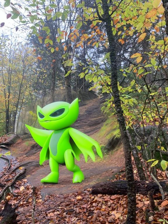 Prompt: a bright green alien walking up the hill