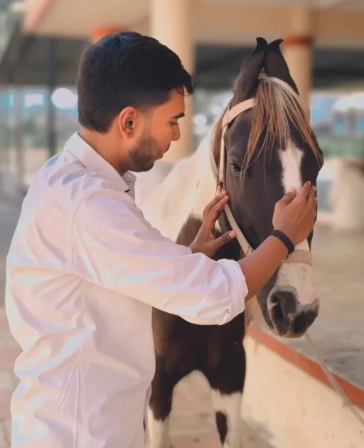 Prompt: In a serene setting, a young man gently interacts with a black-and-white horse, showcasing a tender moment of connection and trust between them. The man, dressed in a crisp white shirt, leans slightly towards the horse, his hands reaching out to caress its face with a look of calm affection. The environment appears to be an outdoor stable, softly illuminated by natural light, enhancing the warm and intimate atmosphere of the scene. The horse, adorned with a simple halter, stands patiently, its expressive eyes reflecting a sense of comfort. This peaceful exchange captures the bond between humans and animals, conveying warmth and harmony in a tranquil outdoor setting.