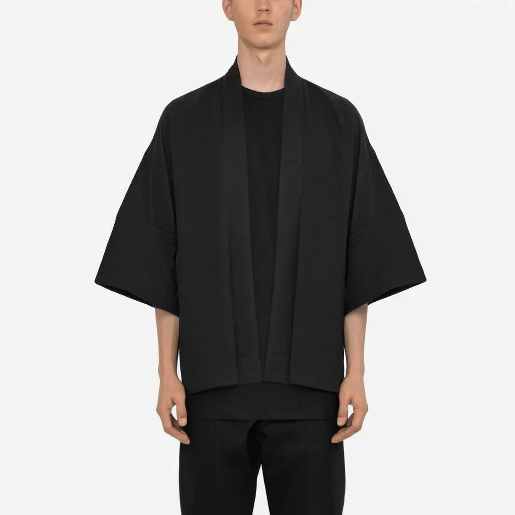 Prompt: Asian male in black outfit with loose fit. Kimono jacket over top should be open. Sleeves are long. Material is cotton and polyester