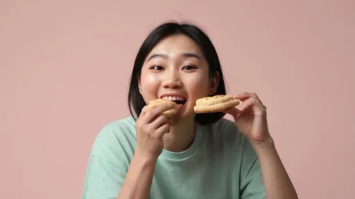 Prompt: Asian person enjoying a biscuit snack. The scene should feature a plain pastel-colored background, with the person depicted with a slightly happy expression on their face as they savor the snack