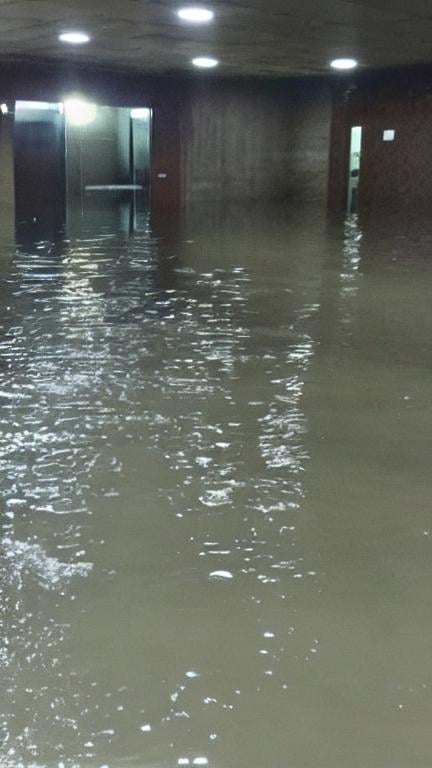 Prompt: man stuck inside a facility with flooded sewage water with no lights in the facility, camera flash, desperate, bad quality, shaky camera, funny