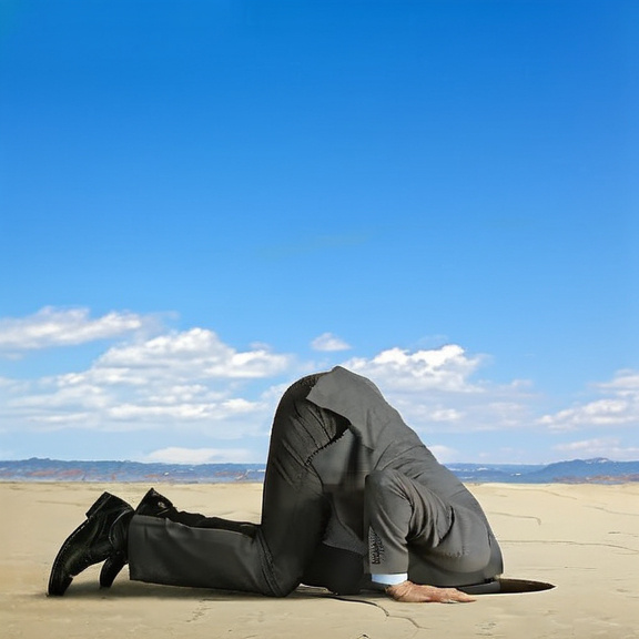 Prompt: picture of man in a business suit with his head buried in the sand on the beach by the ocean, no boats, large waves,