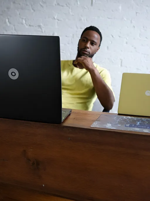 Prompt: a man sitting at a desk with a laptop computer on it's desk and a wooden desk top, Cedric Seaut (Keos Masons), lyco art, clear focus, a photocopy