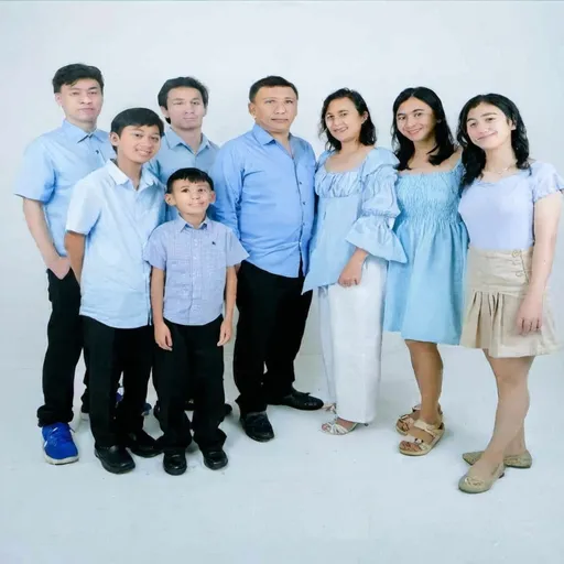 Prompt: a family poses for a picture in front of a white background for a portrait session in a studio in a blue dress, Basuki Abdullah, private press, white background, a photocopy