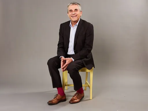 Prompt: Make a single image of the subject on a gray background with no shadows on the floor or background. Point the subject's pupil's and iris's point more toward the camera taking the image. Do not add any generative conent to the image, only source from the file. 