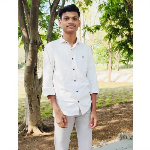 Prompt: Standing confidently amidst a serene outdoor park scene, a young man in a crisp white button-up shirt and light grey pants exudes a calm demeanor. Surrounded by lush green trees and vibrant nature, the sunlight filtering through the leaves casts a warm glow, enhancing the inviting atmosphere. His expression is composed, hinting at a sense of ease in the tranquil environment. The composition captures the young man prominently in the foreground, with the blurred greenery creating a pleasant backdrop that emphasizes the refreshing feel of the day. The overall mood reflects a blend of professionalism and relaxation, suggesting a moment of contemplation or simple enjoyment in the beauty of nature.