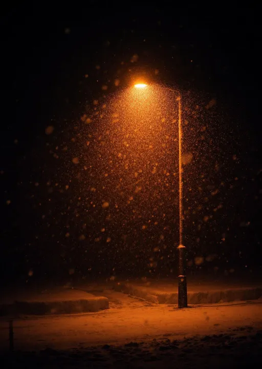 Prompt: A heavy snowfall visible in the warm orange glow of a streetlight at night. Thick snowflakes falling densely through the light creating a soft, dreamy atmosphere. The surroundings are dim and quiet with the snow gently blanketing the ground and the air filled with a magical winter stillness .