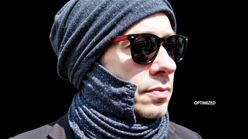 Prompt: This is a digital graphic illustration of a three-dimensional hexagon set against a dark gray background. The hexagon is composed of two intersecting faces, one colored in bright red and the other in dark gray. The red face is on the top left side, while the dark gray face is on the top right side, creating a sharp, geometric contrast. The hexagon casts a subtle shadow to the bottom right, adding a sense of depth and dimension to the image. The background is a smooth, solid dark gray with no additional textures or objects, emphasizing the hexagon as the focal point. At the bottom center of the image, the word "OPTIMIZED" is written in small, white, uppercase letters, slightly centered and aligned with the hexagon's bottom edge. The overall style of the illustration is minimalistic and modern, utilizing clean lines and a limited color palette to create a visually striking effect. The image conveys a sense of simplicity and precision, with a focus on geometric shapes and contrast.