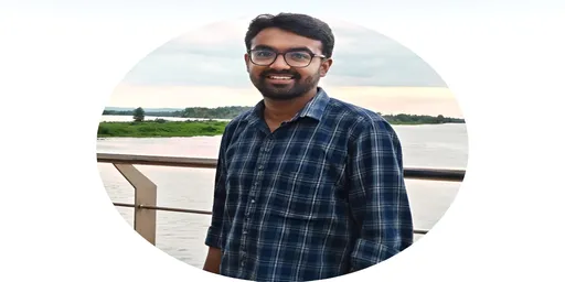 Prompt: A young man stands smiling against a scenic backdrop of water and green landscapes, exuding a relaxed and cheerful demeanor. He wears a blue plaid shirt, and his glasses reflect a sense of calm and approachability, as he leans slightly on a railing. The atmosphere is tranquil, with soft clouds hovering in a light sky, hinting at the peaceful time of day, possibly early evening. The composition showcases not only the subject but also the natural beauty around him, creating a harmonious balance between the individual and the serene environment. The mood is inviting, capturing a moment of joy in nature.