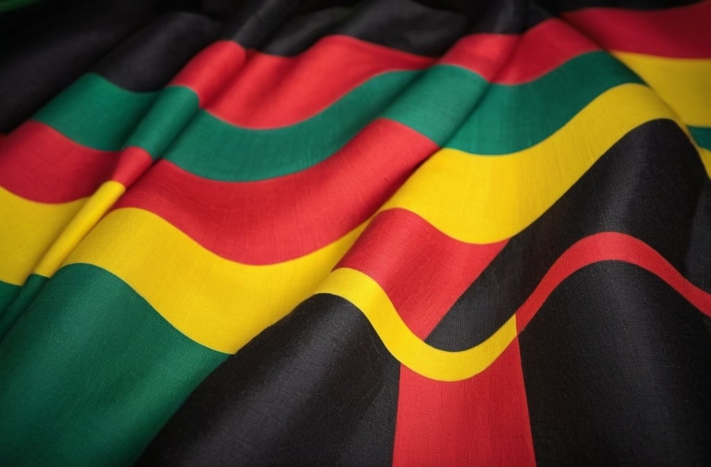 Prompt: flag or textile with red yellow green and black stripes color background, better if concentric
