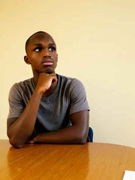 Prompt: a young man sitting at a table with his hand on his chin looking up at the camera with a serious look on his face, Bruce Onobrakpeya, lyco art, profile picture, a character portrait