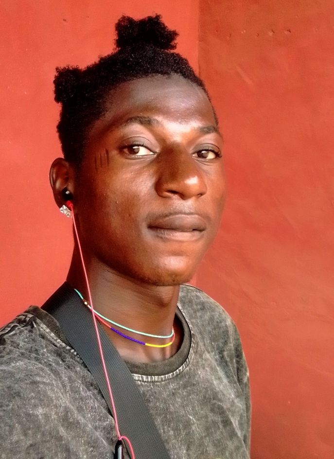 Prompt: ALi Boubacar with a black shirt and a pair of ear buds on his ears and a red wall behind him, Chafik Charobim, figuration libre, stanley artgermm, a picture