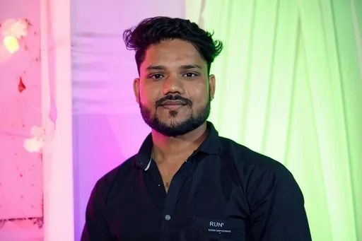 Prompt: A man stands confidently, dressed in a dark, button-up shirt that features a subtle logo. His well-groomed beard complements his strong jawline, while his hairstyle is neat and voluminous, enhancing his charismatic presence. The background is adorned with soft, colorful lighting, primarily in shades of pink and green, creating a vibrant and festive ambience. The scene suggests a celebratory atmosphere, possibly at an event or gathering, as indicated by the lively backdrop and the subject's composed expression. Overall, the image conveys an aura of confidence and warmth, inviting viewers into a moment likely filled with joy and camaraderie.