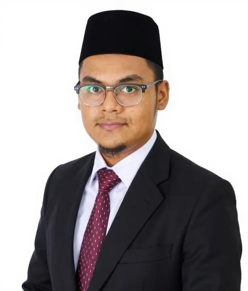 Prompt: A young man with a serious expression poses against a plain white background, exuding professionalism and confidence. He wears a formal black suit complemented by a light blue dress shirt and a patterned burgundy tie. Atop his head rests a traditional black cap, known as a songkok, which adds a cultural touch to his attire. His glasses enhance his intellectual appearance, while a neatly trimmed beard frames his face. His body should be turned 45 degrees to the right, but he is facing forward The overall composition conveys a sense of formality and readiness, as if he is prepared for a significant professional or academic occasion. 