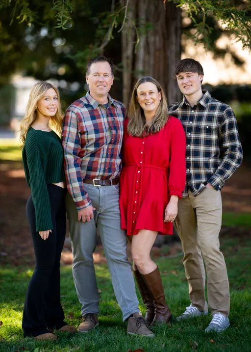 Prompt: Change this family photo to a winter Tahoe background at Christmas 