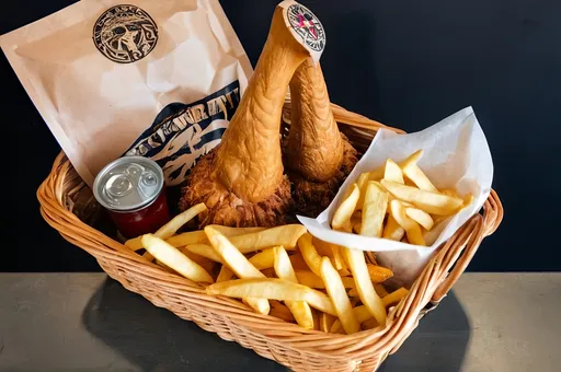 Prompt: Delicious takeaway order of Odin in a basket with chips and pilks 