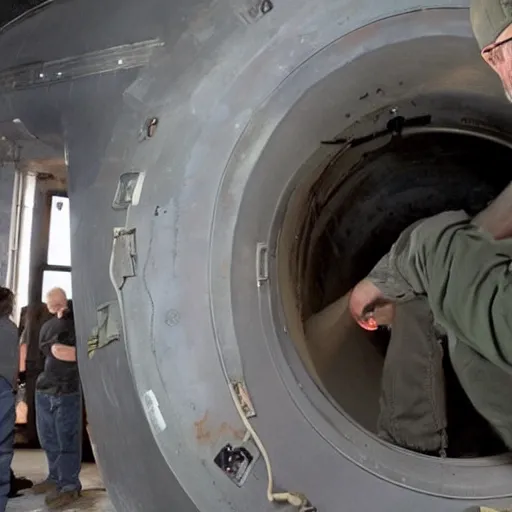 Image similar to Jamie Hyneman tinkering with an ICBM in a missile silo