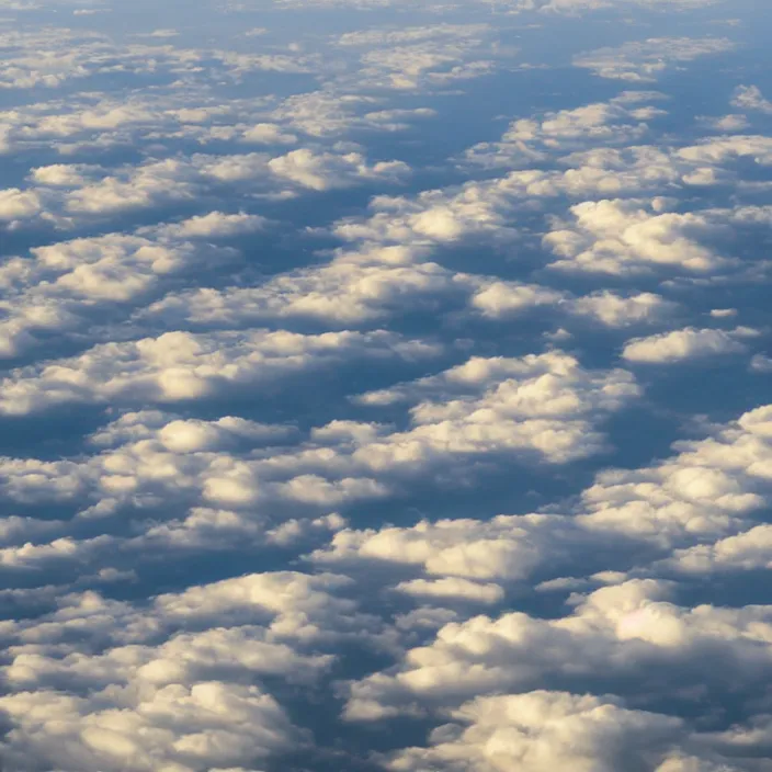 Prompt: Endless clouds towering high, seen from a plane, no ground visible, very detailed, 8k resolution, pale yellow hue