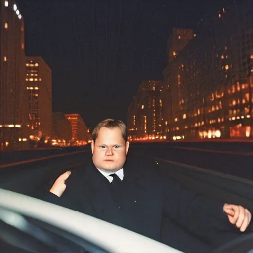 Prompt: 1 9 9 8 andy richter wearing a black wool coat and necktie in his car driving through the streets of chicago at night, point of view from back seat of car, warm, cozy, safe atmosphere