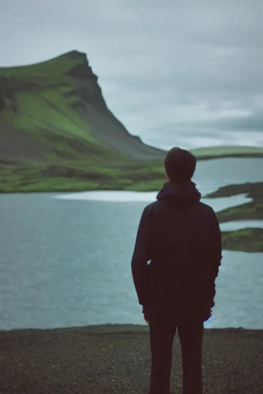 Image similar to kodak color plus 2 0 0 photograph of a skinny guy looking at beautiful iceland scenery, front view, vaporwave colors, grain, moody lighting, moody aesthetic,