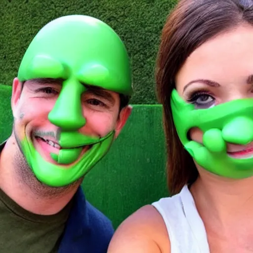 Prompt: a man in a green rubber mask takes a selfie with a girl