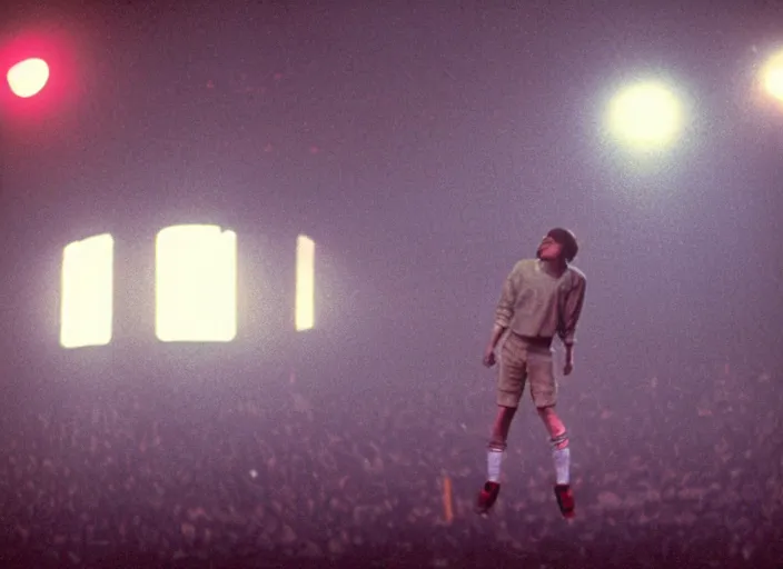 Prompt: a still from the breakfast club ( 1 9 8 5 ) of a man lifelessly floating 1 0 feet above a football oval at night, illuminated by a red light