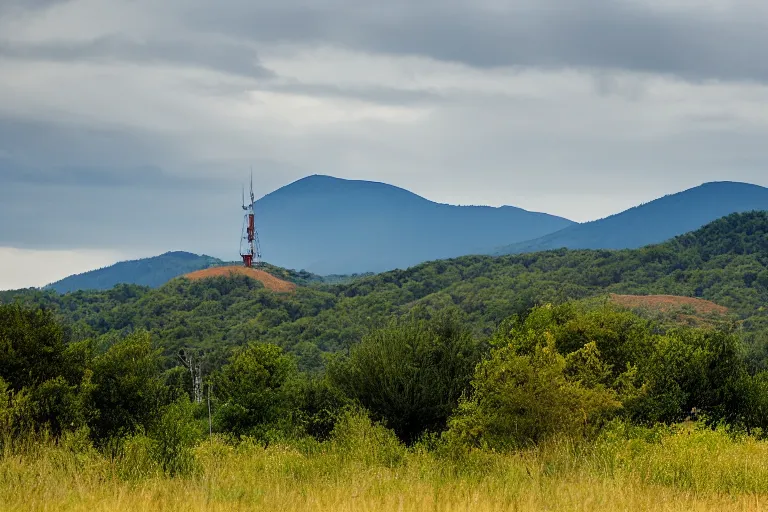 Prompt: a hill with a radio tower next to a pond, hills in background. telephoto lens photography.