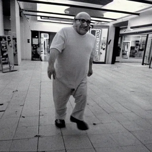 Prompt: A creepy photo of Danny Devito chasing you in an abandoned shopping mall, disposable film