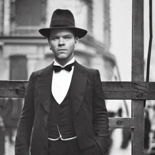 Image similar to ewan mcgregor is dressed as a gentleman at early 2 0 th century paris. he is standing next to an easel. that easel has a canvas on it.