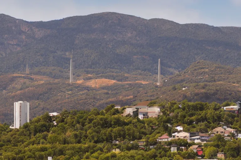 Image similar to looking down road, buildings on both sides. hills background with radio tower on top. telephoto lens compression.