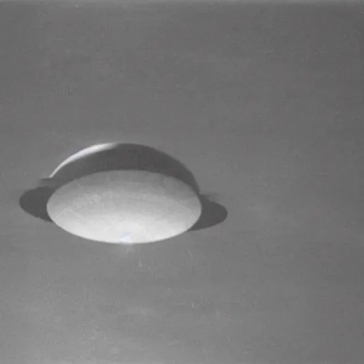 Prompt: the photo shows a large, silver disk - shaped object hovering in the sky above a mountain range. the object appears to be surrounded by a bright, glowing aura. there is no sign of any engines or propulsion system, and the object seems to be completely silent. the photo was taken by a professional photographer. this is the first ever declassified photo of a flying saucer.