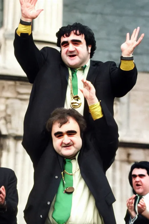 Image similar to gordon brown mixed with john belushi, dark black hair, wearing a green umbro tracksuit and gold necklace star shaped medallion, hands raised in the air,