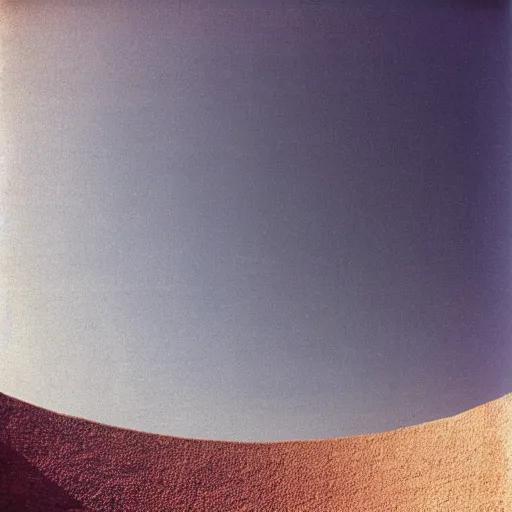 Prompt: a photo taken from inside a massive circular Non-Euclidean clay building sitting in the desert, vintage photo, beautiful cinematography, blue sky, film grain, symmetrical, James Turrell