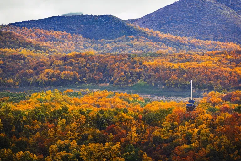 Image similar to a hill with a radio tower next to a pond, autumn hills in background. telephoto lens photography.