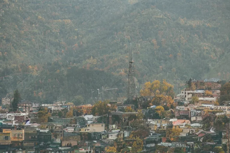 Image similar to warehouses lining a street, with an autumn mountain directly behind, radio tower on mountain, lens compressed, photography