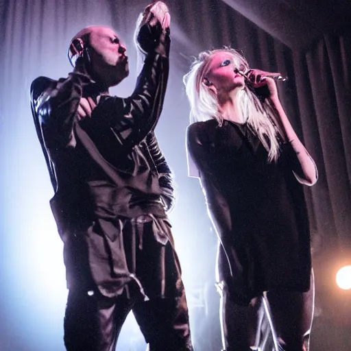 Prompt: a stage photo of a man and a woman performing darkwave music, wearing clothes by rick owens, with short blond hair and faces veiled