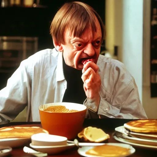 Image similar to mark e smith sitting at a table eating a big stack of pancakes, fork and knife in hand, drooling and licking his lips, photograph