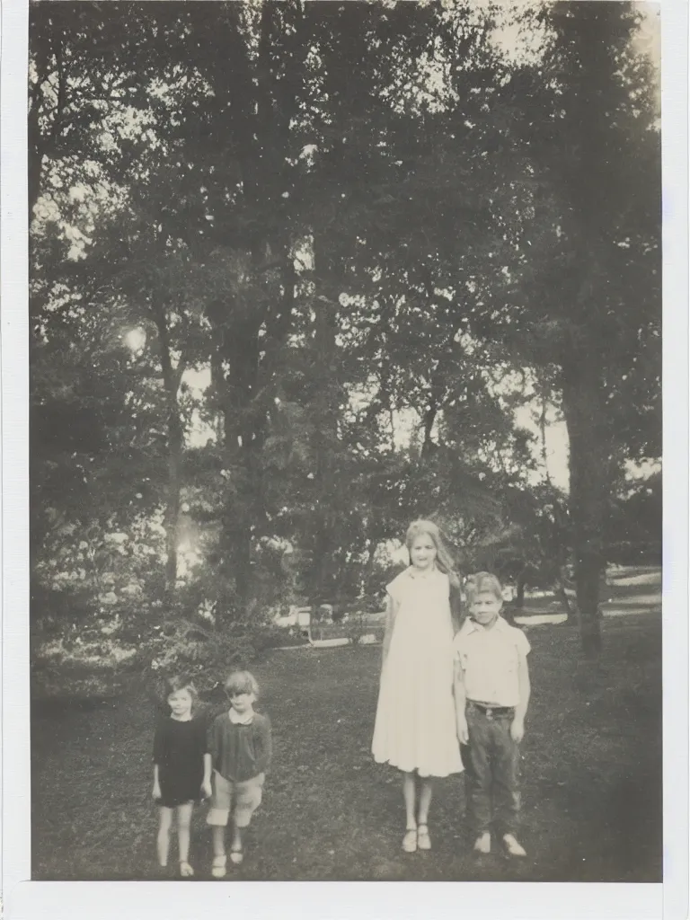 Prompt: a boy and a girl posing for a picture, a strong light behind them, at night, some trees in the background, old polaroid