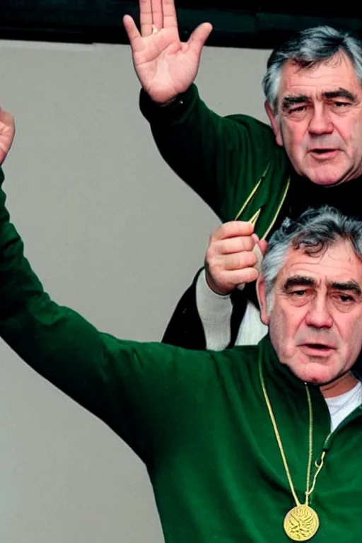 Image similar to gordon brown, dark black hair, wearing a green umbro tracksuit and gold necklace star shaped medallion, hands raised in the air,