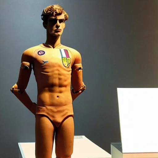 Image similar to “ a realistic detailed photo of a guy who is an attractive humanoid who is half robot and half humanoid, who is a male android, soccer player antoine griezmann, shiny skin, posing like a statue, blank stare, at the museum, on display ”