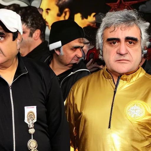 Image similar to jafar panahi mixed with john belushi and gordon brown, clean shaven, wearing an umbro sports tracksuit and gold necklace with large star shaped intricate gold medallion