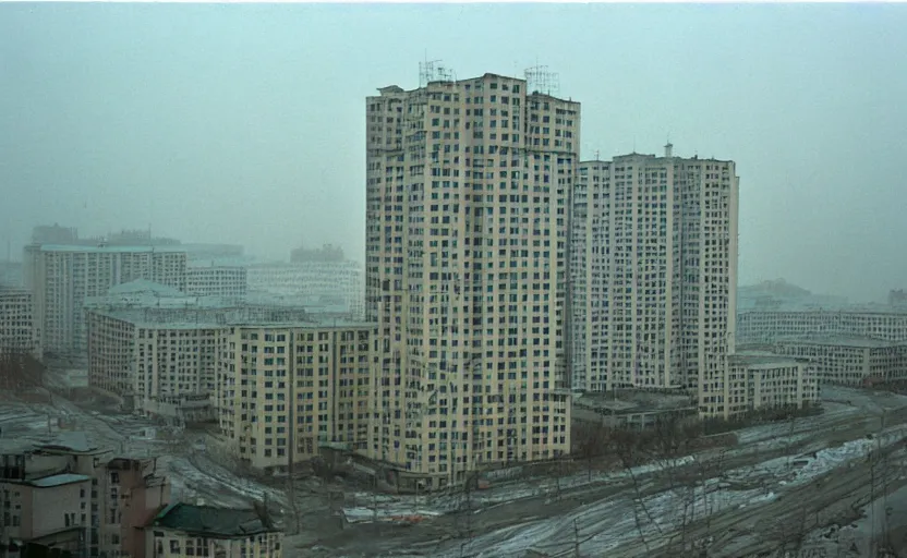 Image similar to 80s historic footage of a soviet city with soviet high rise and pedestrians, aerial photo night vision, Cinestill 800t 18mm, heavy grainy picture, very detailed, high quality, 4k panoramic, billboards and streetlight at night, rain, mud, foggy