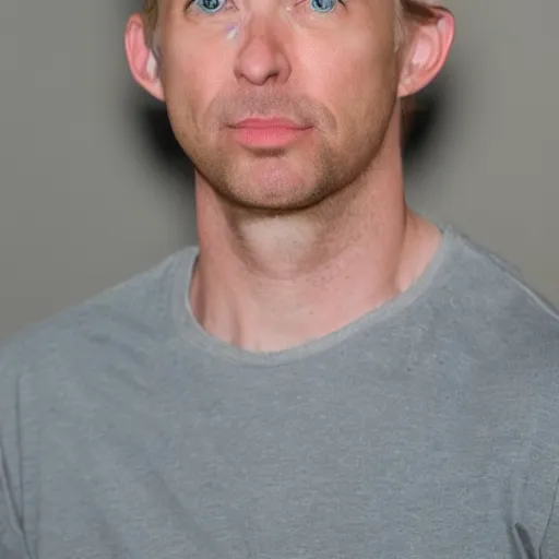 Prompt: full face color photograph of a 40 year old very handsome skinny white man with short, curly, light blond hair and very small slanted blue eyes, dressed in a white t shirt, gray shorts and black socks, with a small mole to the right of his very thin lips, with a straight nose and blond stubble on his round face, and an earring in the left ear. He resembles a lion.