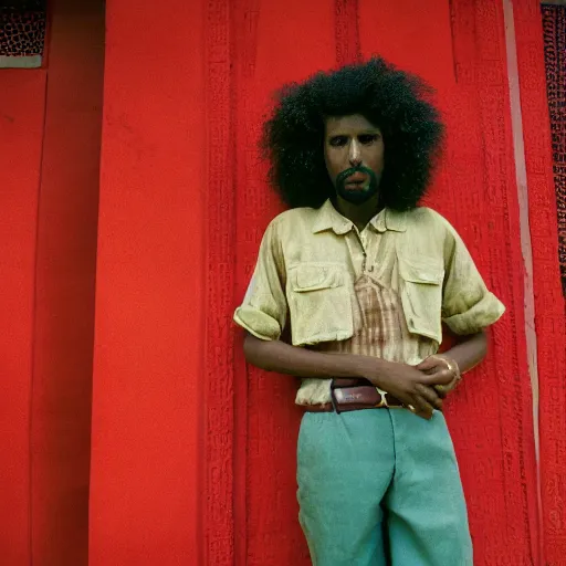 Image similar to a somali man with curly hair, in a movie still by wes anderson of a beautiful day on an island, visible magic energy, dream high fashion costumes, cinestill 8 0 0 t eastmancolor, high quality, heavy grain