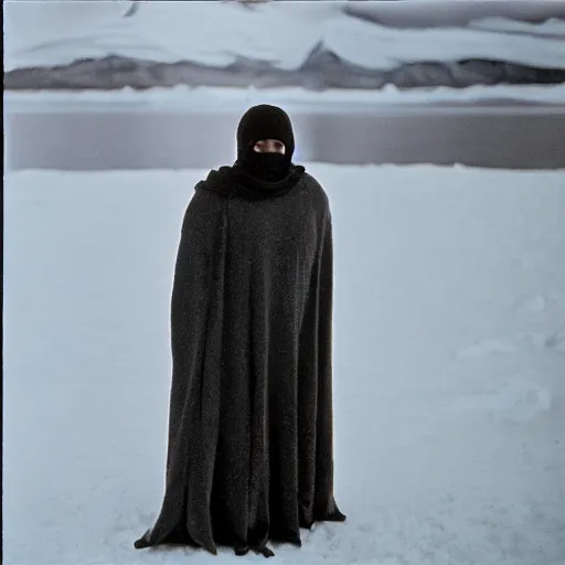 Image similar to a man wearing a long cloak and hood, in antarctica, film still, arriflex 3 5