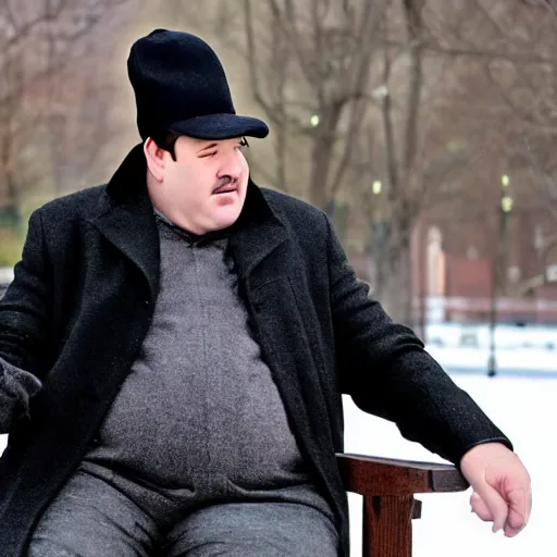 Image similar to Kevin Malone wearing a black ushanka hat and black wool overcoat sitting on a park bench during the winter