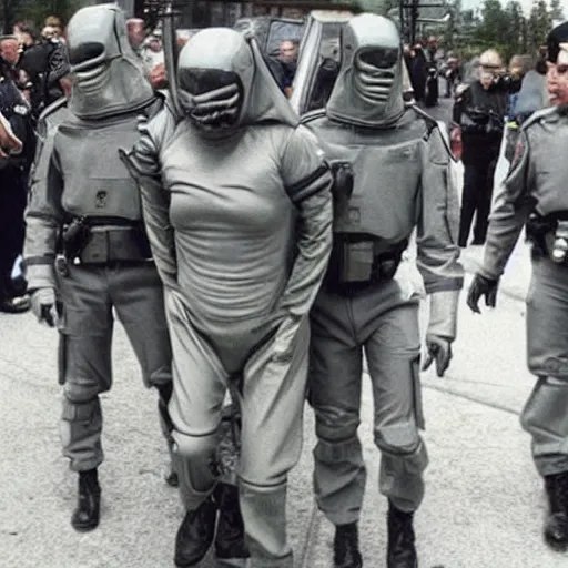 Image similar to extraterrestrial zeta reticulan grey alien, being arrested by spetsnaz