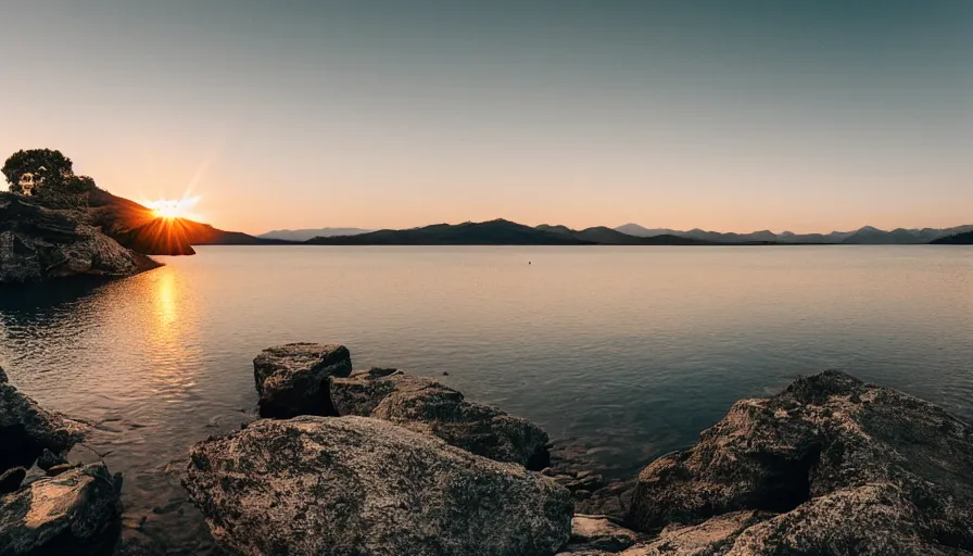 Image similar to cinematic wide shot of a lake with a rocky foreground, sunset, a bundle of rope is in the center of the lake, leica, 2 4 mm lens, 3 5 mm kodak film, f / 2 2, anamorphic