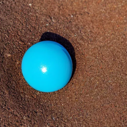 Image similar to macro photo bright day of a tiny sphere containing alternate reality world placed on the ground gobi desert in background dreamy swirling colors